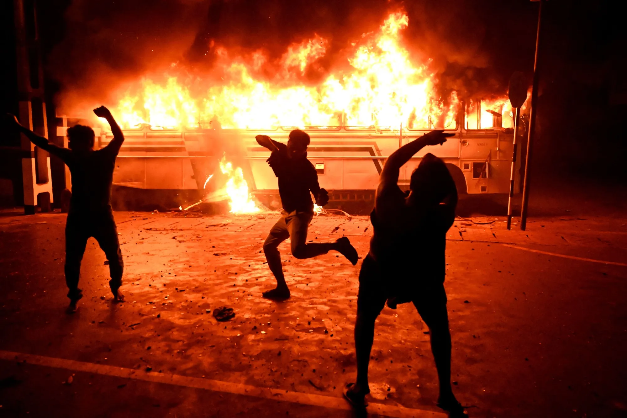 Protesters set a bus on fire during a demonstration outside the Sri Lankan president's home in Colombo on March 31.