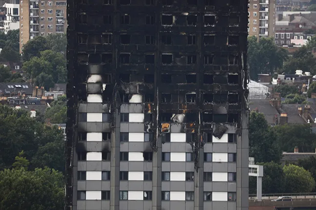 Unburned lower floors with untouched cladding in tact and the burnt out upper floors of London’s Grenfell Tower, June 18, 2017.&nbsp;