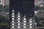 Unburned lower floors with untouched cladding in tact and the burnt out upper floors of London’s Grenfell Tower, June 18, 2017. 