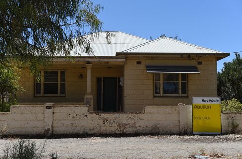 An auction sign stands on the edge of a residential property in the township of Broken Hill.