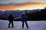 Skiers look east to the high peaks of the Rocky Mountains while skiing on man-made snow, Dec. 4, 2021, in Beaver Creek, Colo. Olympic athletes in Alpine skiing and other outdoor sports dependent on snow are worried as they see winters disappearing. (AP Photo/Robert F. Bukaty, File)