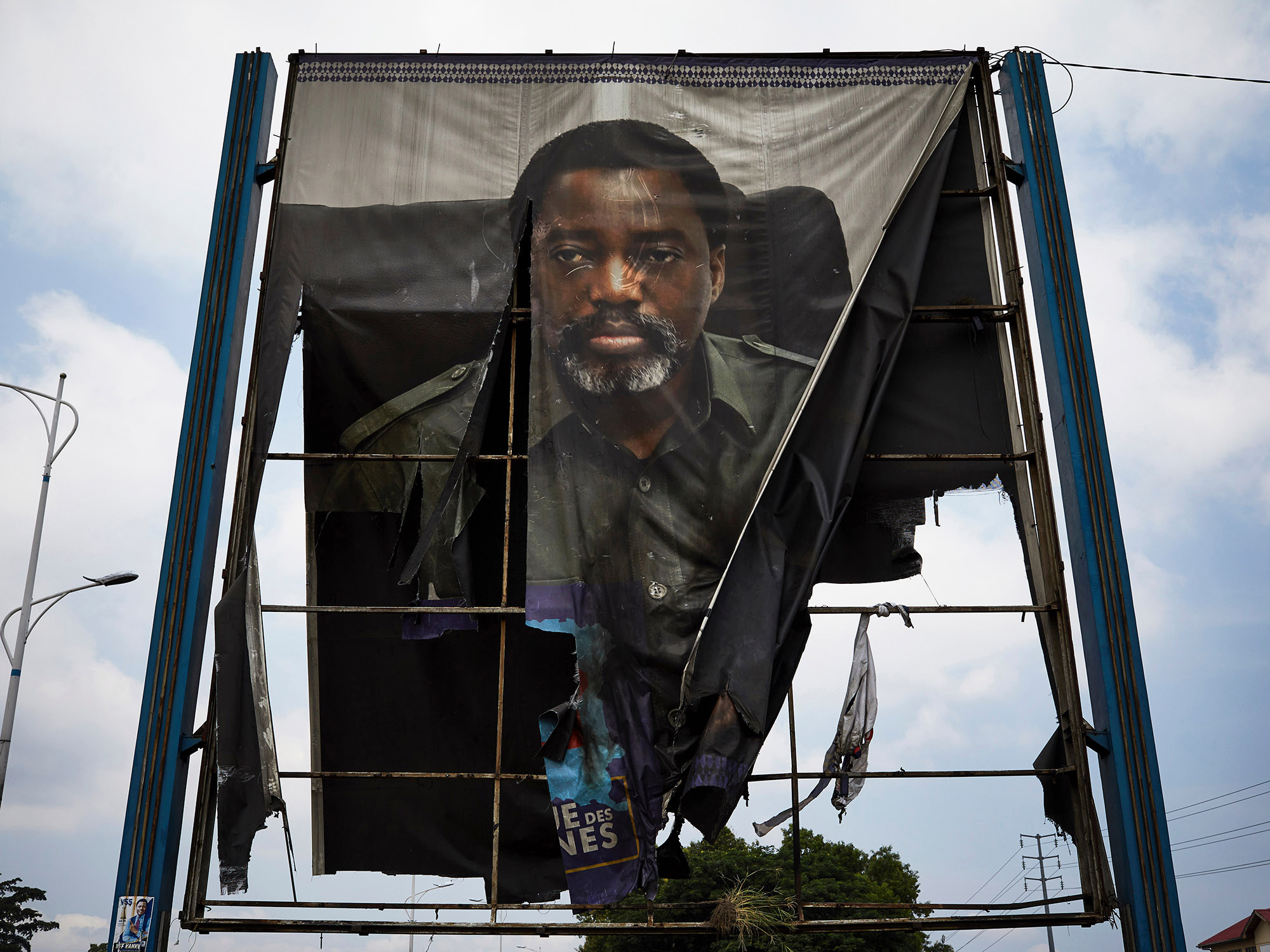 A burned billboard of Congo’s then outgoing President Joseph Kabila in January 2019.
