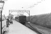 Electric locomotive and train at a station, 1913.