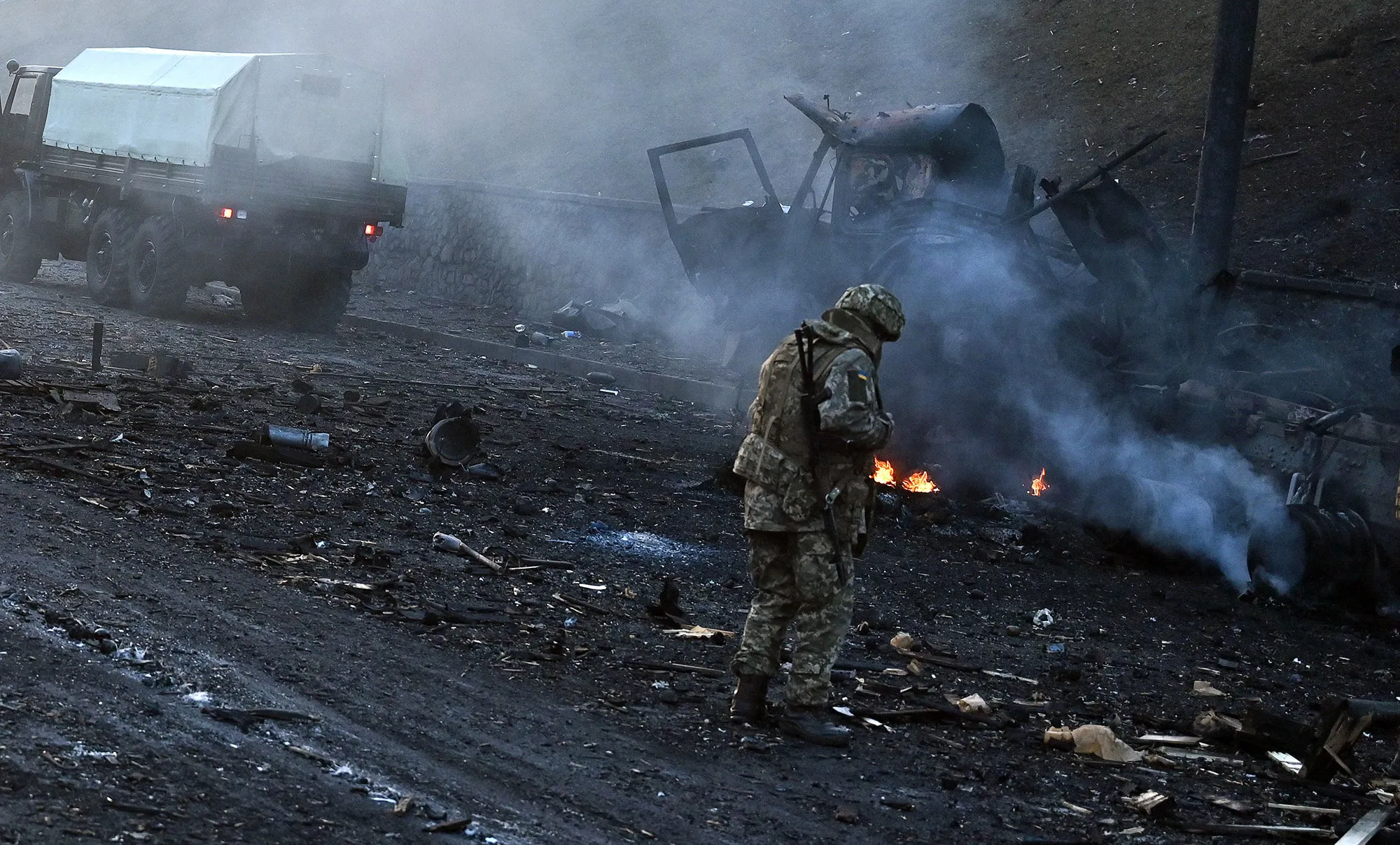 Ukrainian service members&nbsp;look for unexploded shells after fighting in&nbsp;Kyiv on&nbsp;Feb.&nbsp;26.