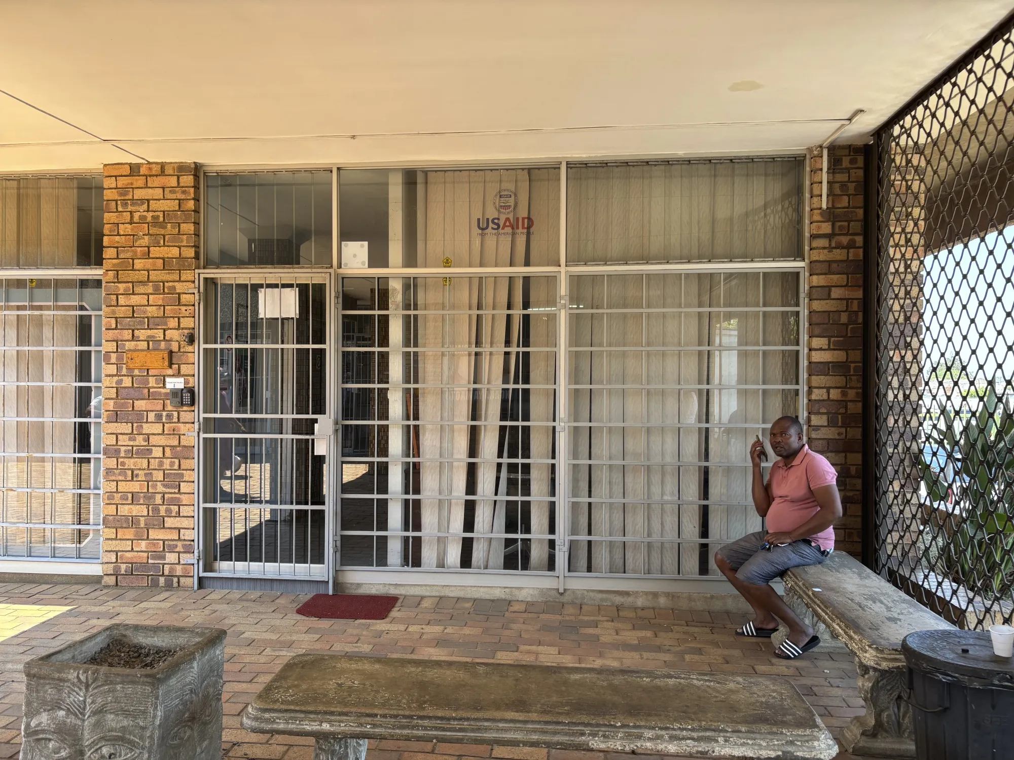 A man sits outside the closed Isizinda Sempilo clinic in the Johannesburg township of Soweto.