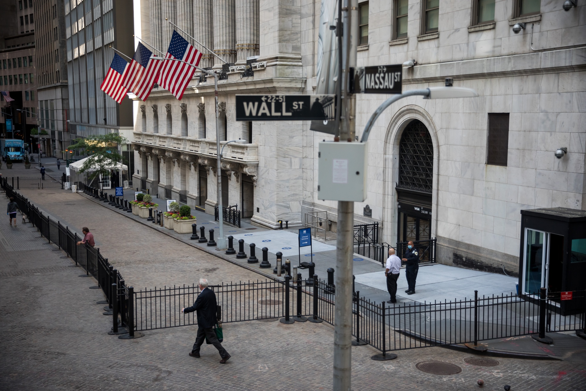A pedestrian passes the the New York Stock Exchange (NYSE).
