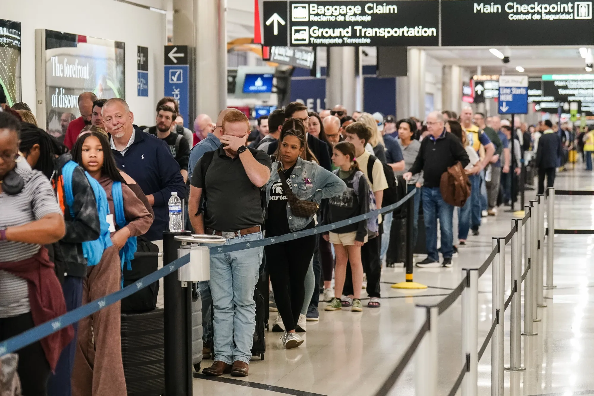 Travelers wait in line at a TSA&nbsp;checkpoint at Hartsfield-Jackson Atlanta International Airport&nbsp; on March 27.