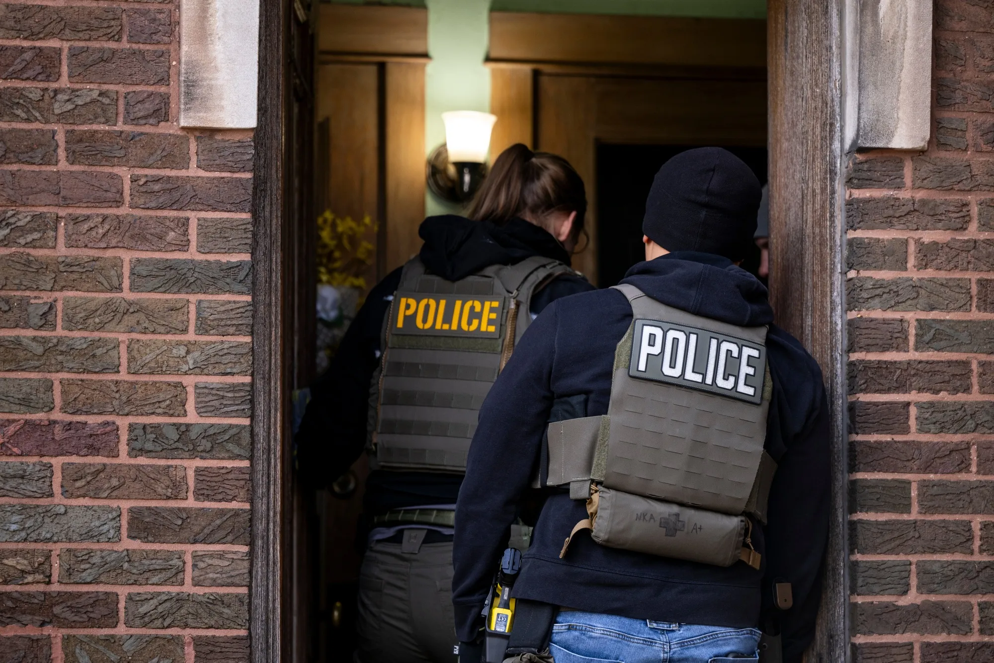 Agents enter an apartment building during a multi-agency targeted enforcement operation in Chicago in January.
