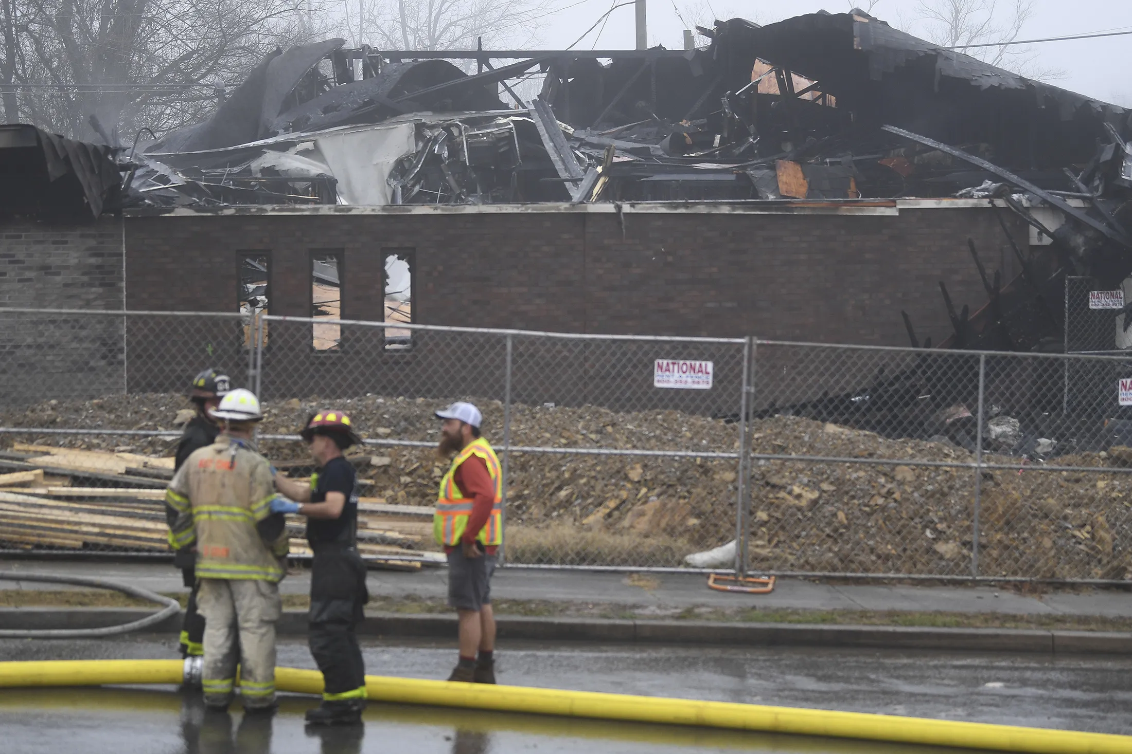 Emergency responders gather as firefighters put out a fire at the Planned Parenthood building in Knoxville, Tenn., on Dec. 31.
