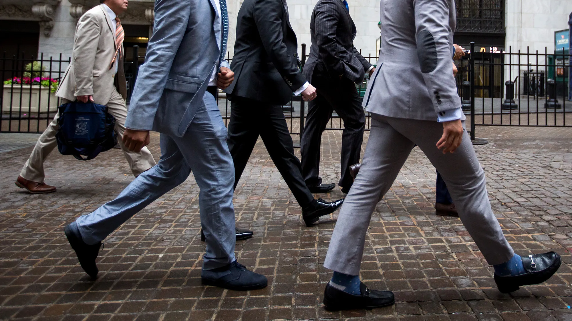 Pedestrians pass in front of the New York Stock Exchange.