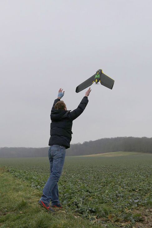 Drone operator Benjamin Bouly launches an eBee drone to collect crop data for Airinov.