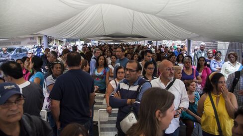 People wait outside validation center.