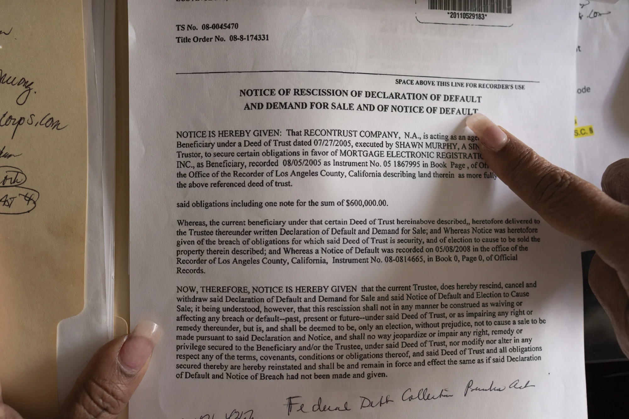 a finger points at a document which is part of a legal case