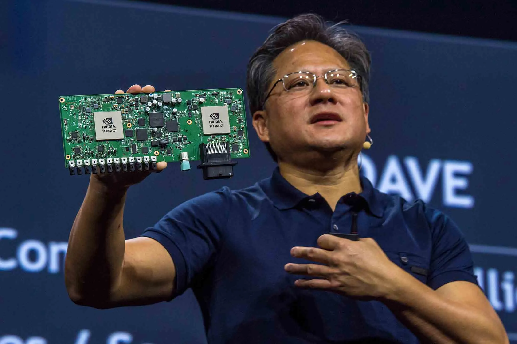 Jen-Hsun Huang, Nvidia’s chief executive officer, holds a Nvidia Drive PX auto-pilot computer at the 2015 GPU Technology Conference.

