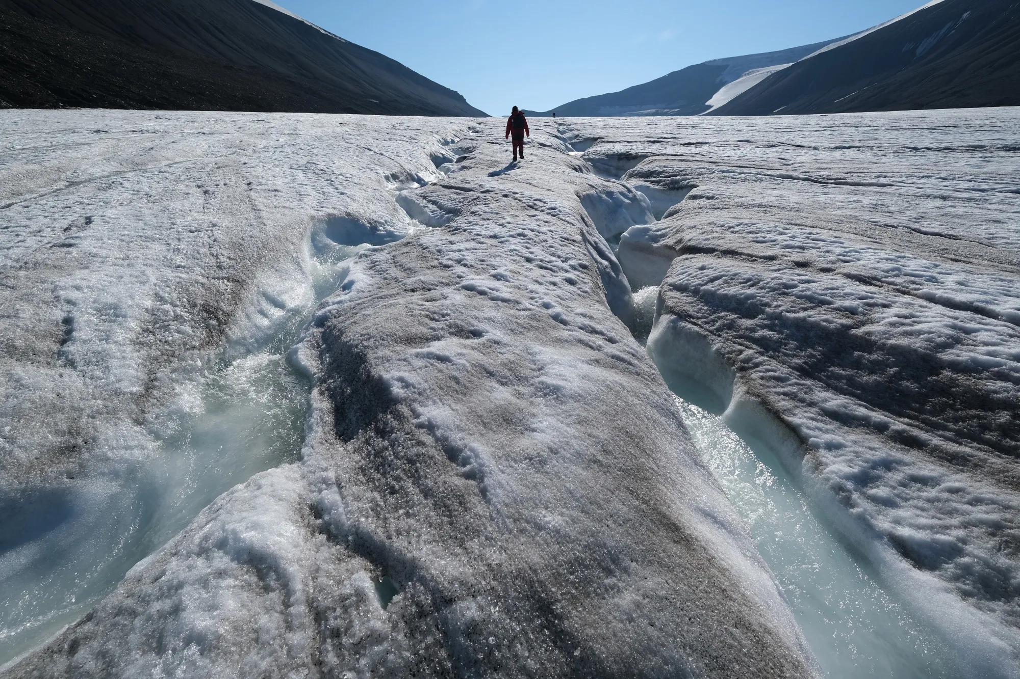A hiker walks along the Longyearbreen glacier on the Svalbard archipelago.&nbsp;