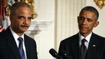 Attorney General Eric H. Holder Jr. (L) speaks while flanked by President Barack Obama while announcing his resignation, September 25, 2014 in Washington, DC.
