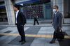 Pedestrians walk past an electronic stock indicator displaying share prices of the Tokyo Stock Exchange in Tokyo on October 31, 2018. - Tokyo stocks rallied on October 31 as optimism returned to Asian markets and investors hunted bargains after recent dips, while watching corporate earnings reports. (Photo by Behrouz MEHRI / AFP) (Photo credit should read BEHROUZ MEHRI/AFP/Getty Images)