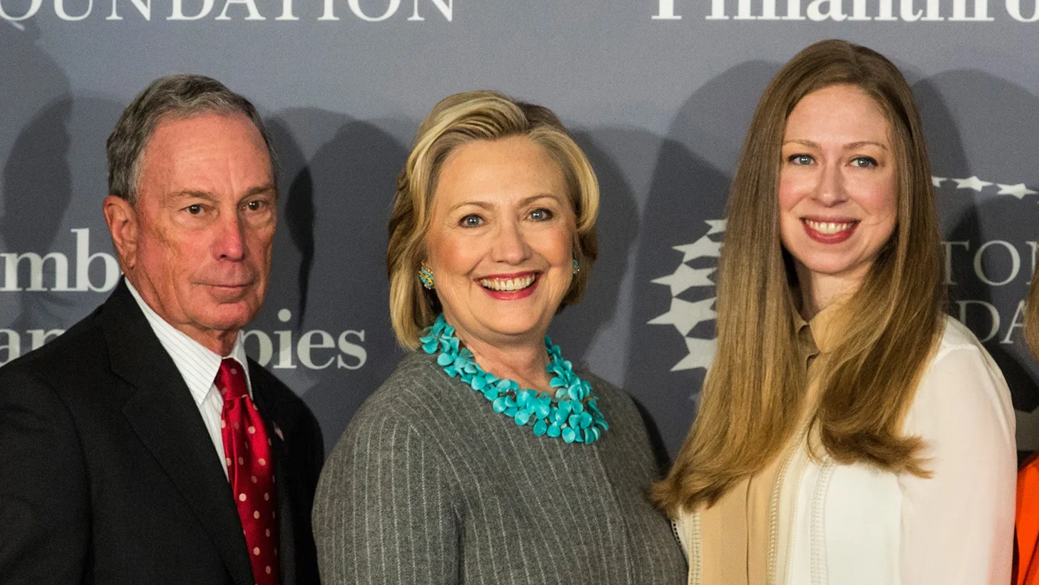 Former Mayor of New York City Michael Bloomberg, former Secretary of State Hillary Clinton, and Chelsea Clinton pose for a photo at a press conference on Dec. 15, 2014, in New York City.
