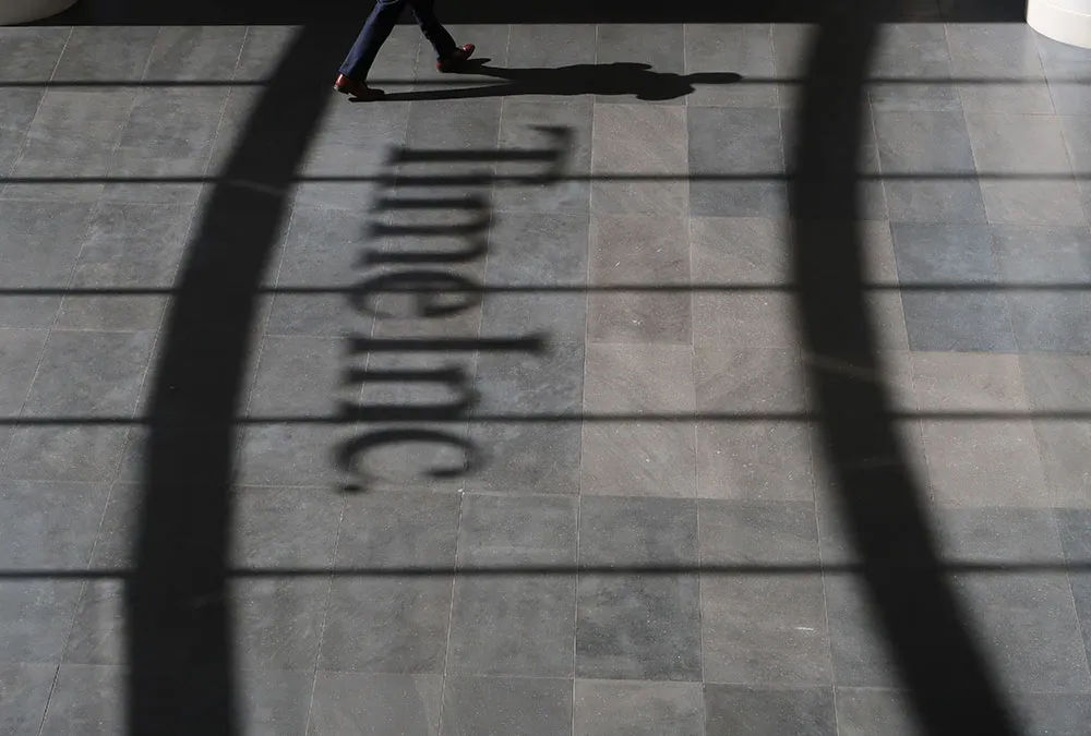 A person walks past the logo of Time Inc. in the lobby of their office headquarters in New York City.
