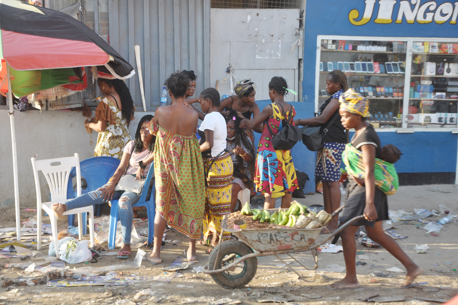 A street vendow pushes a wheelbarrow in Luanda, Angola.