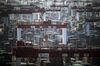 Containers sit stacked next to gantry cranes at the Yangshan Deep Water Port in Shanghai, China, on Tuesday, July 10, 2018. China told companies to boost imports of goods from soybeans to seafood and automobiles from countries other than the U.S. after trade tensions between the world's two biggest economies escalated into a tariff war last week.