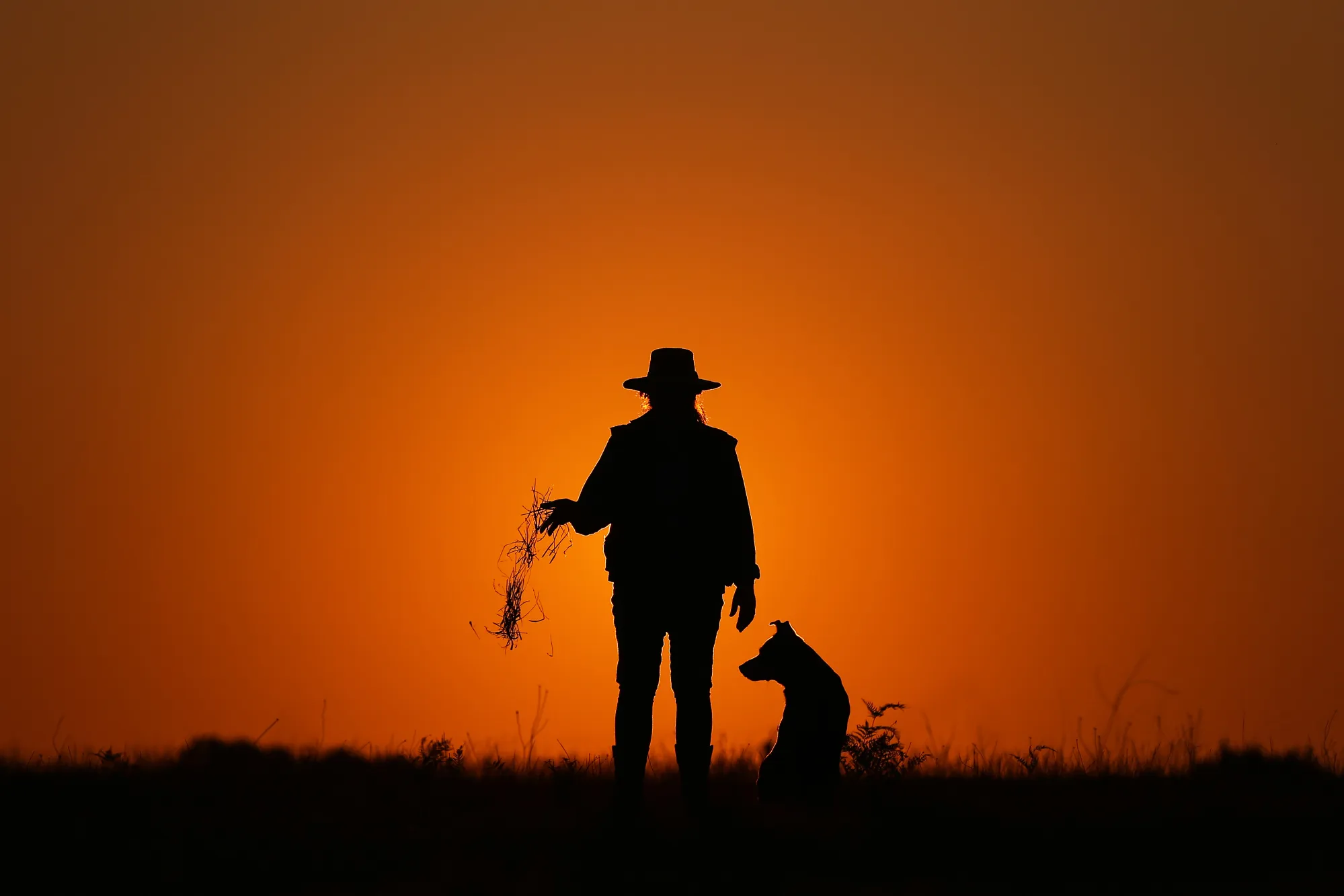 Farmer Leeanne Oldfield and her dog Jett at her farm in Wandandian, New South Wales, Australia.