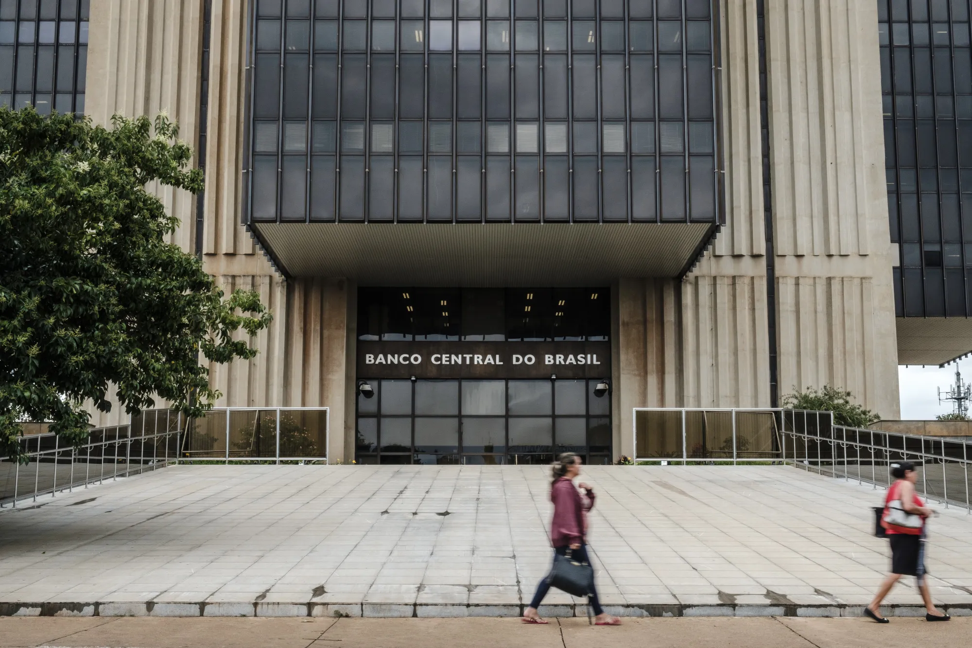 Pedestrians pass in front of the Central Bank of Brazil headquarters in Brasilia.