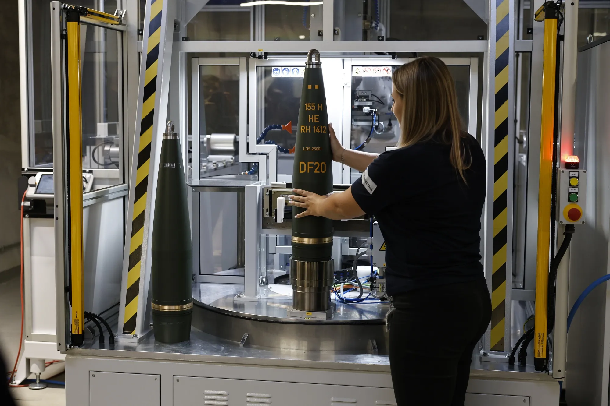 A worker finalizes artillery munitions at a factory in Unterluess, Germany.