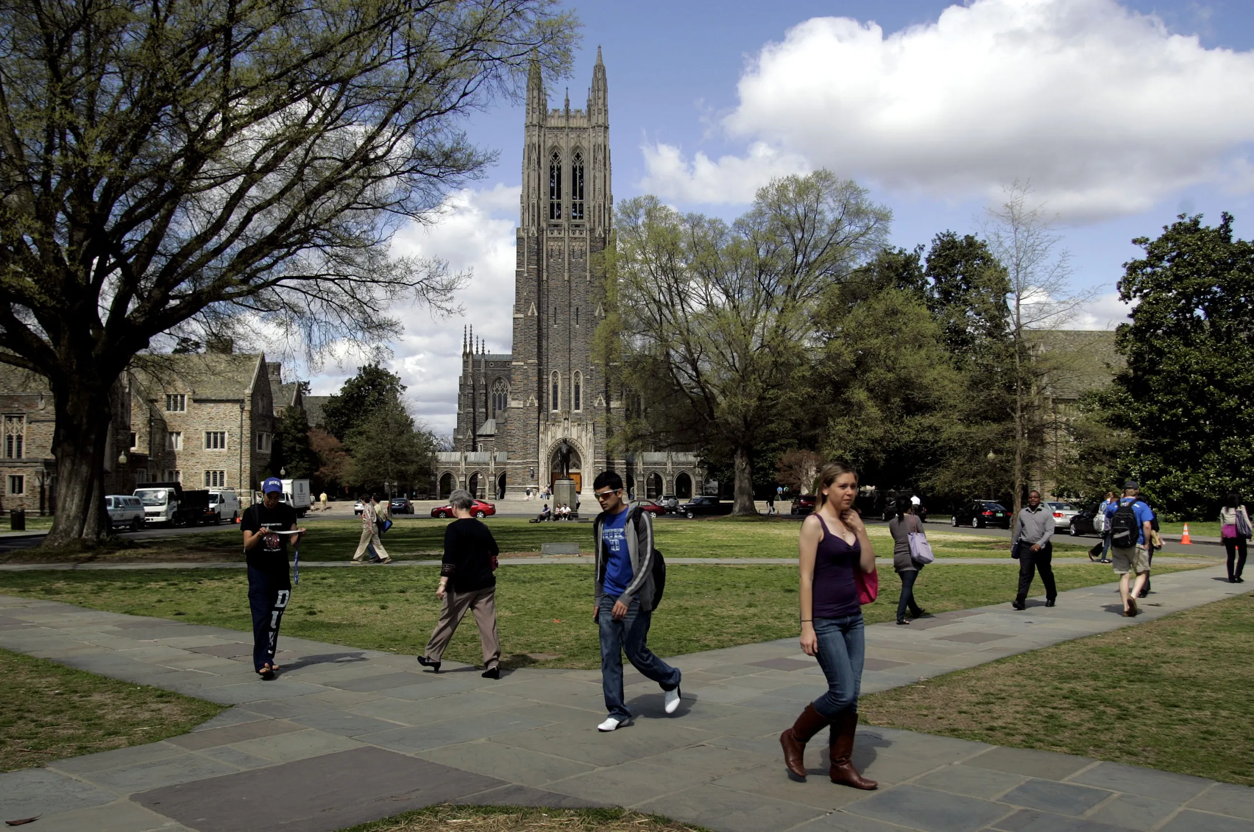 People walk by Duke Chapel on the campus of Duke University in Durham, North Carolina.