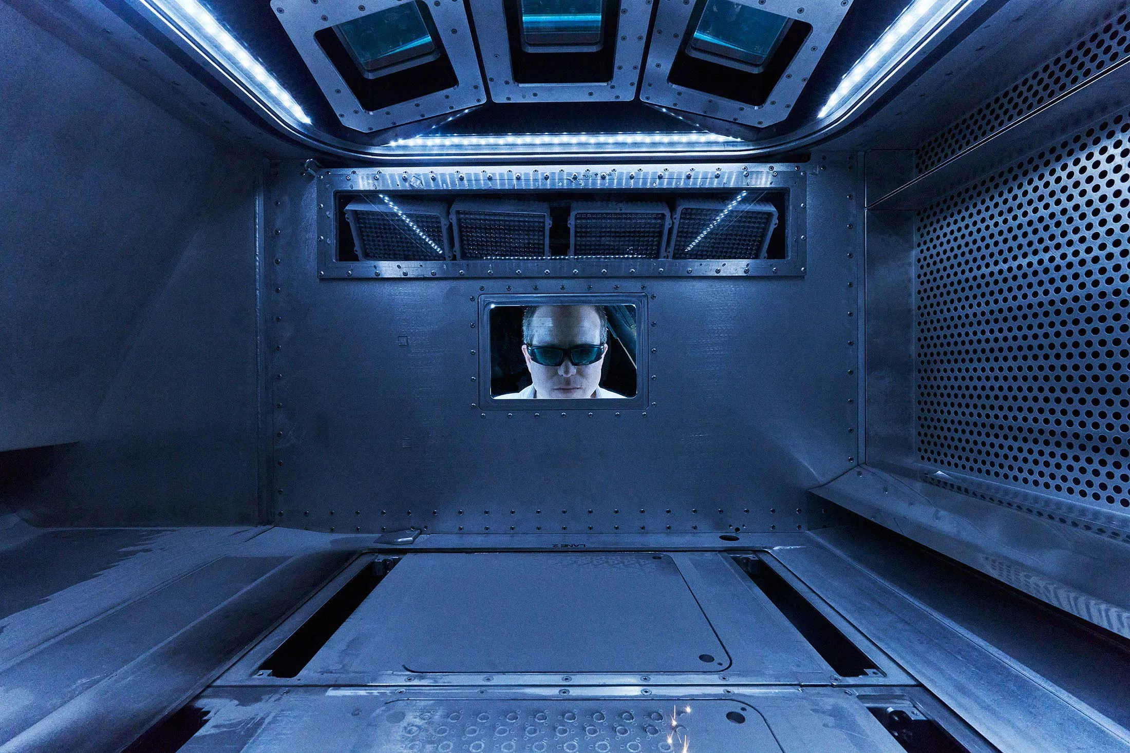 Freeform Future co-founder and Chief Executive Officer Erik Palitsch watches one of the company’s 3D printers in operation.