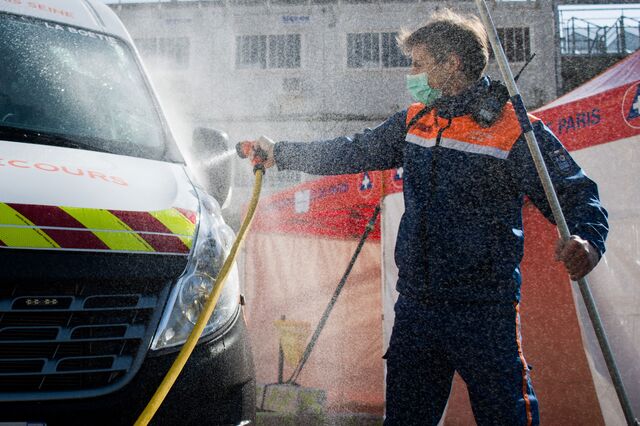 Members of the civil protection ambulance service carry out disinfecting cleaning work in Paris on March 31, 2020.