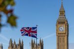 A British Union flag flies from a souvenir stall near the Houses of Parliament in London. Photographer: Jason Alden/Bloomberg