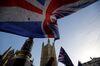 Anti-brexit campaigners wave Union and EU flags outside the Houses of Parliament in central London.