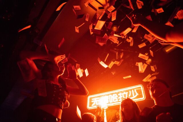 At Wuhan nightclub Hepburn, throwing hundred dollar bills.