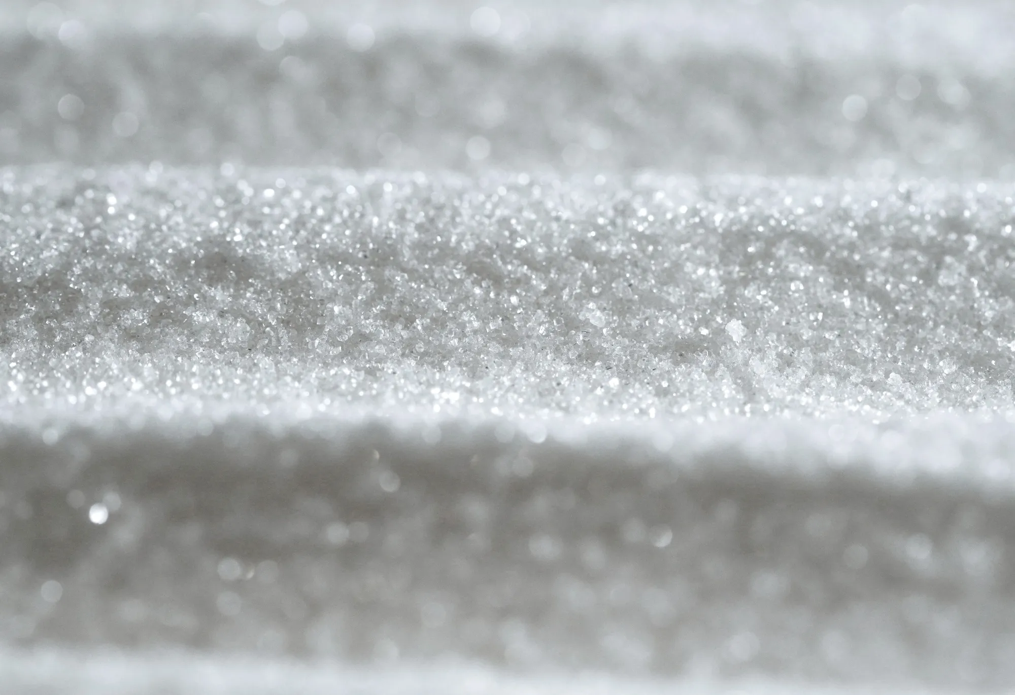 Granules of refined white sugar.
