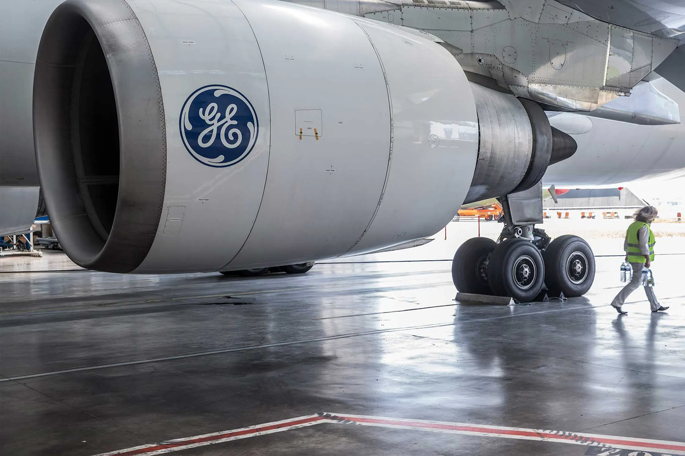 The General Electric&nbsp;logo sits on a GE Aviation CF6-80C jet engine as it hangs from the wing of an Airbus A300-600 Beluga super transporter aircraft.