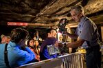 A retired miner shows visitors a canary cage during an underground tour of a former active mine at the Exhibition Coal Mine in Beckley, West Virginia, U.S., on Thursday, Aug. 10, 2017. 