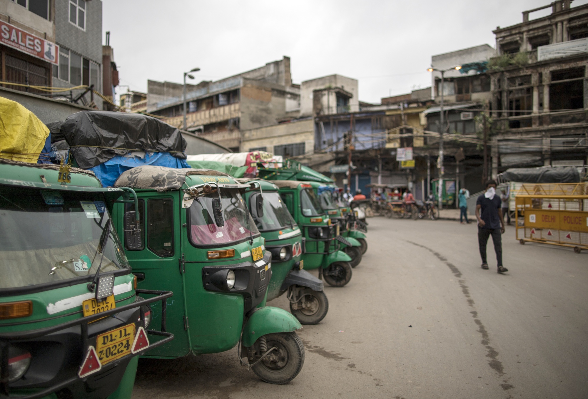 Auto rickshaws sit parked on a street in New Delhi on Aug. 31.
