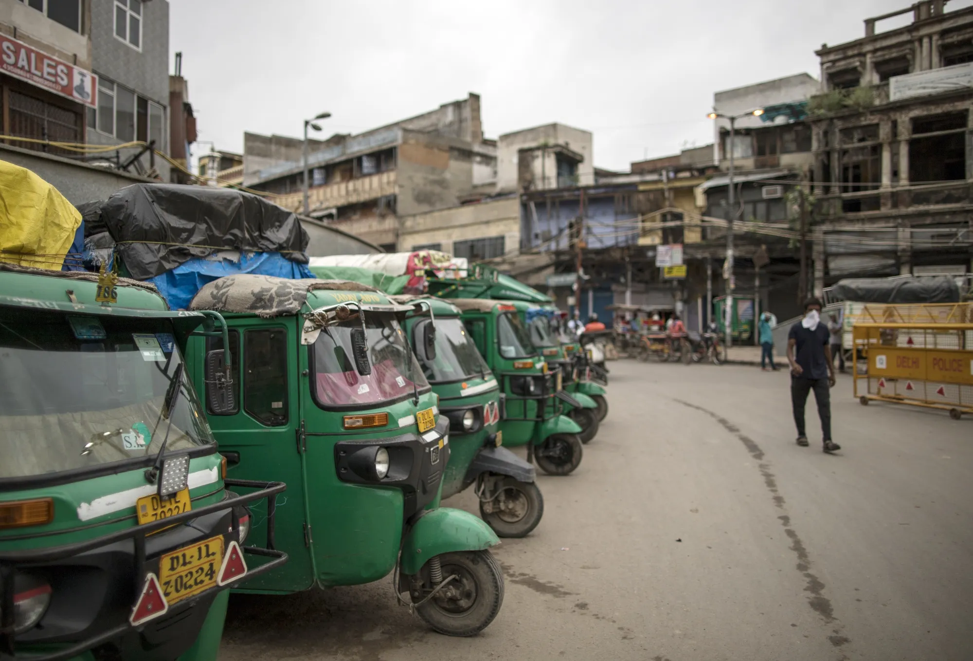 Auto rickshaws sit parked on a street in New Delhi on Aug. 31.