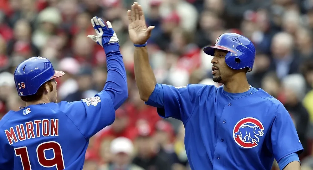 Chicago Cubs' Matthew Murton, left, gets a high five from teammate Derrek Lee after hitting a home run in the first inning of their game against the Cincinnati Reds Monday April 3, 2006, in Cincinnati, Ohio.