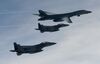 A U.S. Air Force B-1B Lancer bomber (top) fly with South Korean jets over the Korean Peninsula during a South Korea-U.S. joint live fire drill on July 8, 2017 in Korean Peninsula, South Korea.