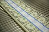 Stacks of $1 dollar notes bearing the name of U.S. Treasury Secretary Steven Mnuchin move through a machine at the U.S. Bureau of Engraving and Printing in Washington, D.C., U.S., on Wednesday, Nov. 15, 2017.