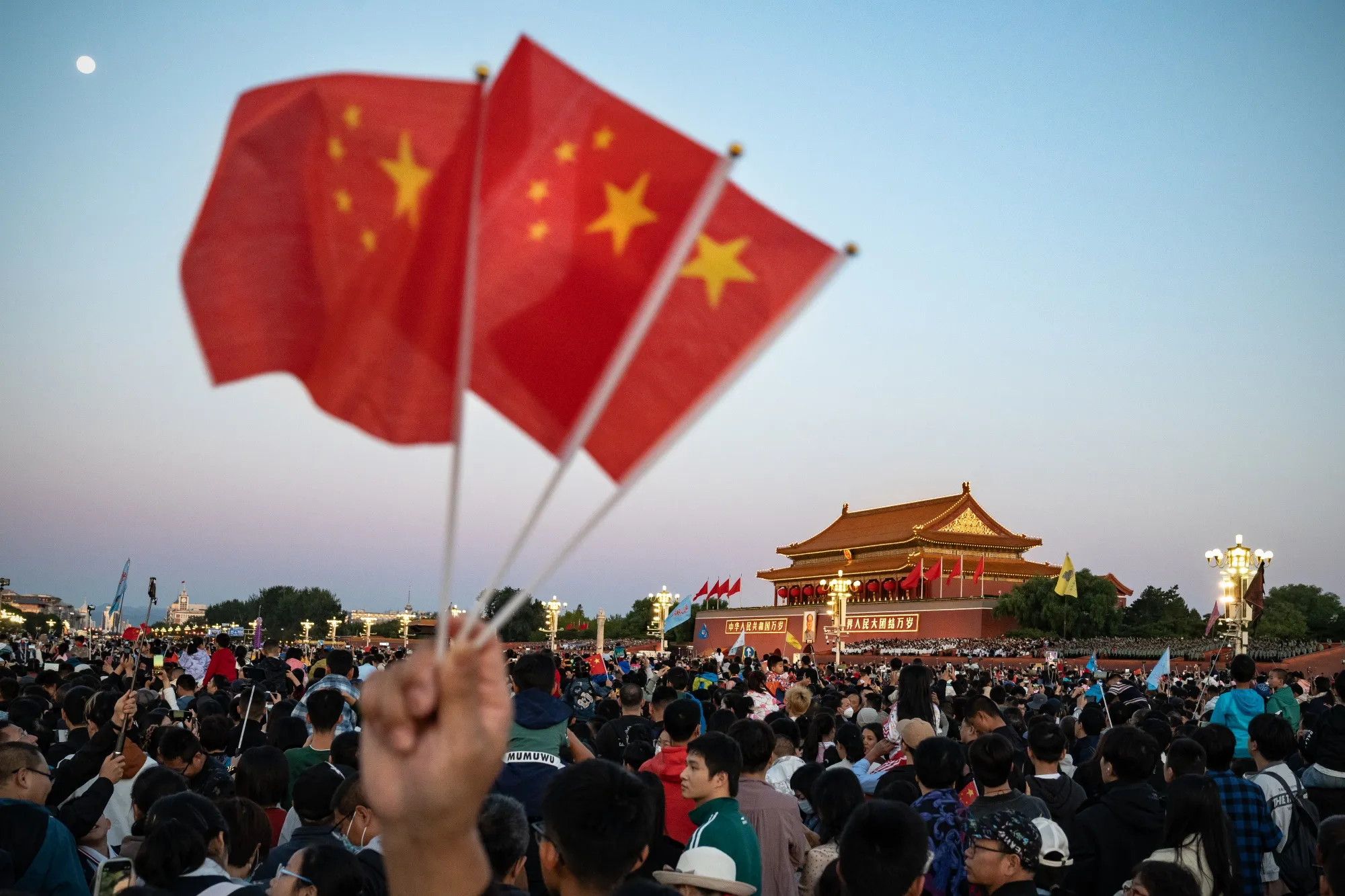 Visitors gather for the flag raising ceremony at Tiananmen Square to mark National Day in Beijing.