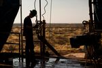 A worker waits to connect a drill bit on Endeavor Energy Resources LP's Big Dog Drilling Rig 22 in the Permian basin outside of Midland, Texas, U.S.