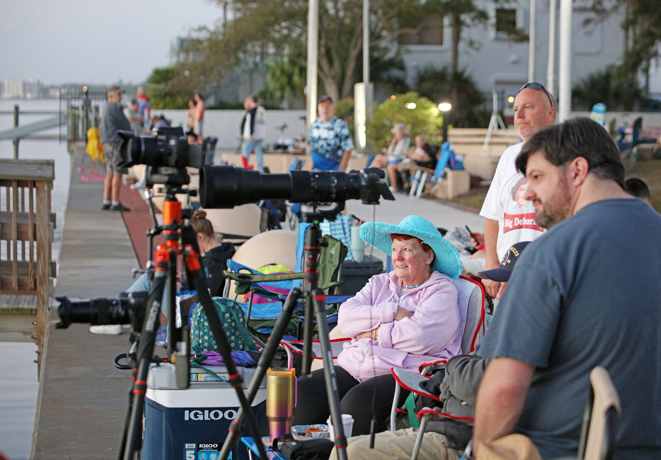 Space enthusiasts watch the sunrise from a park in Titusville, Florida several hours before NASA's Artemis II Space Launch System (SLS) rocket is scheduled to launch from the Kennedy Space Center on April 1, 2026. On Wednesday three men and one woman are set to embark on the first crewed journey to the Moon since 1972, a landmark odyssey that aims to launch the US into a new era of space exploration. The NASA mission dubbed Artemis 2 has been years in the making after facing repeated setbacks, but is finally scheduled to take off from Florida as early as April 1 at 6:24 pm (2224 GMT). Photographer: Gregg Newton /AFP/Getty Images