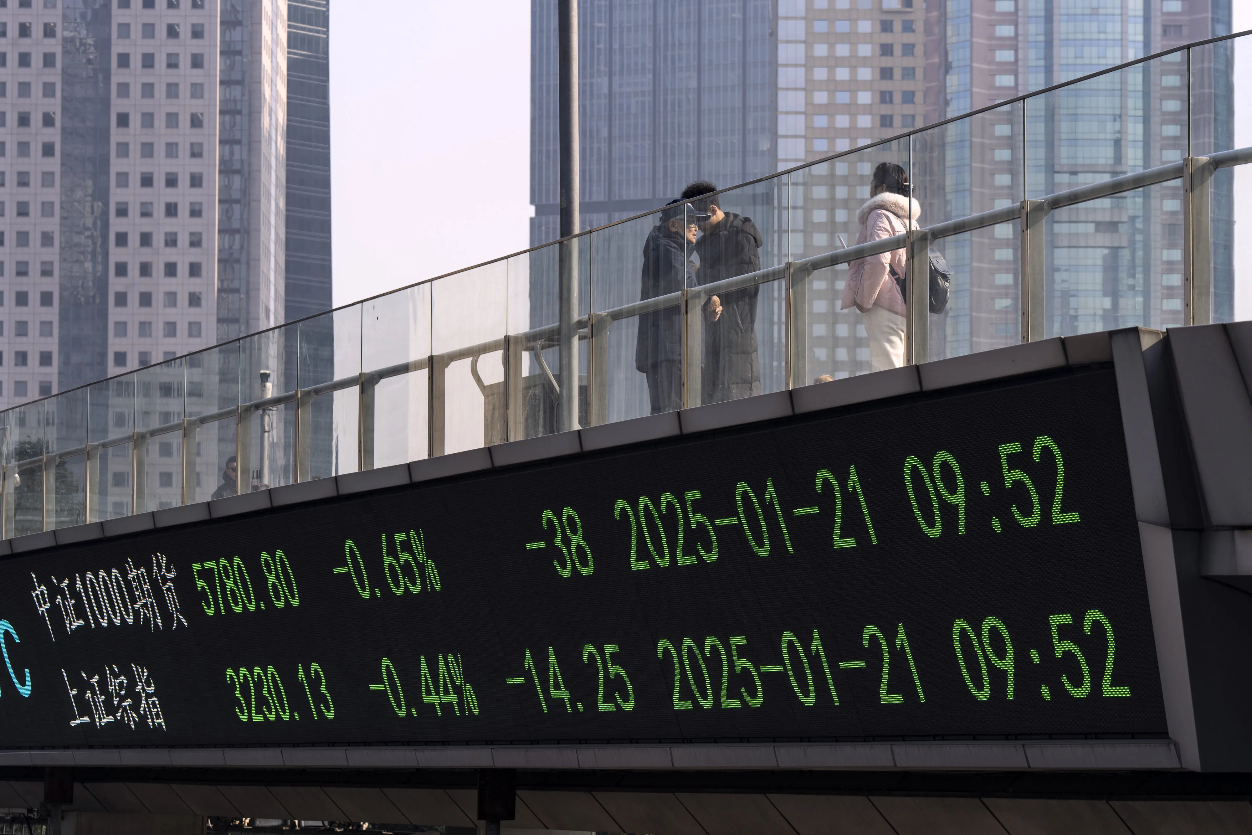 An electronic ticker displays the figures for Chinese stock indexes in Pudong's Lujiazui Financial District in Shanghai