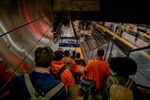 Commuters walk toward a Long Island Rail Road train at New York City’s Penn Station.
