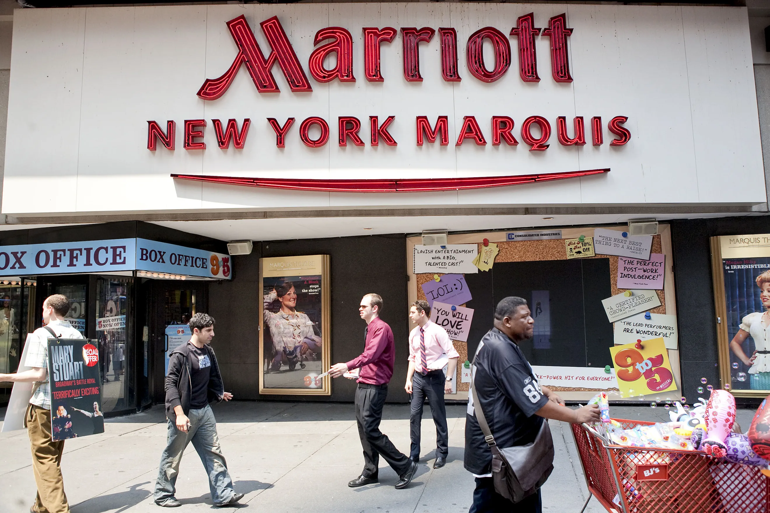 Pedestrians pass outside the Marriott Marquis Hotel in Times Square