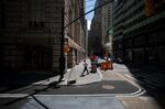 A pedestrian walks along Broadway near the New York Stock Exchange (NYSE).