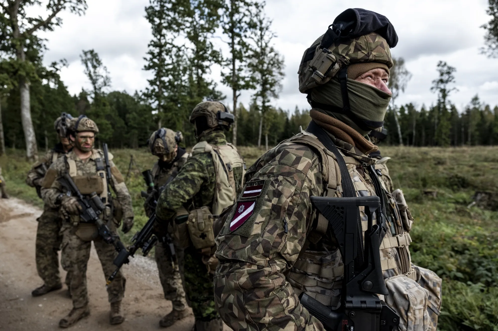 British, Latvian, and Canadian soldiers during NATO-linked military exercises in Latvia.